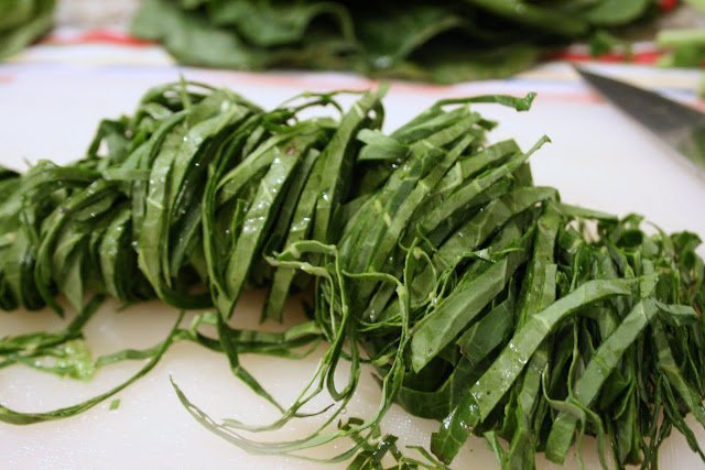 Stir fry collard greens by shredding them