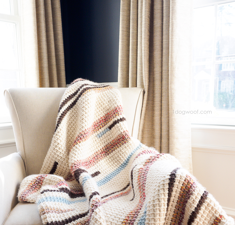 Tunisian crochet pattern for Sunset Stripes Blanket on armchair