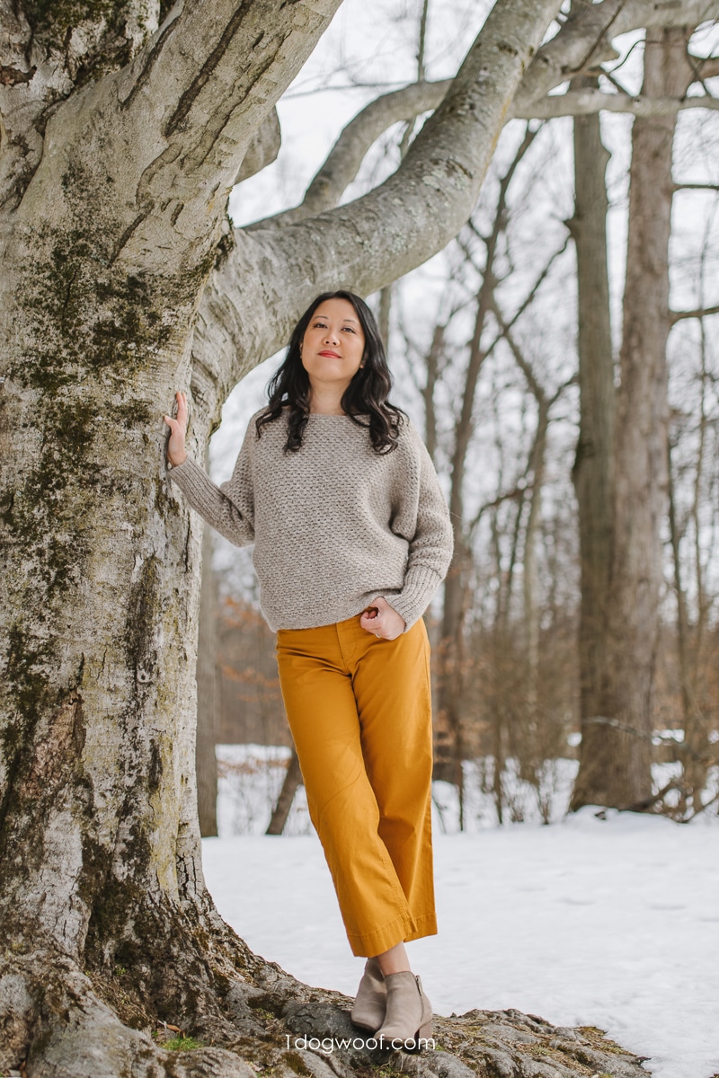 plume sweater against a tree